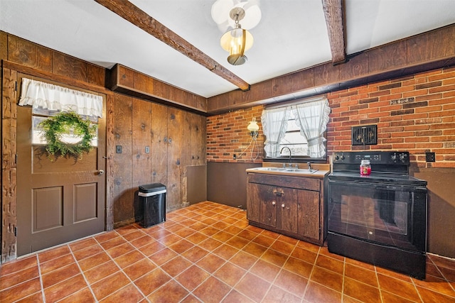 kitchen featuring beam ceiling, black range with electric stovetop, wooden walls, and light tile patterned flooring