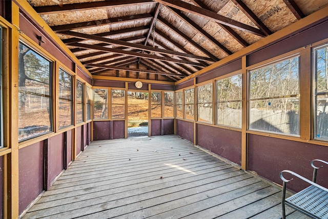 unfurnished sunroom featuring lofted ceiling