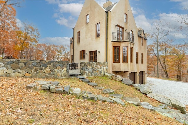 view of side of home featuring a balcony