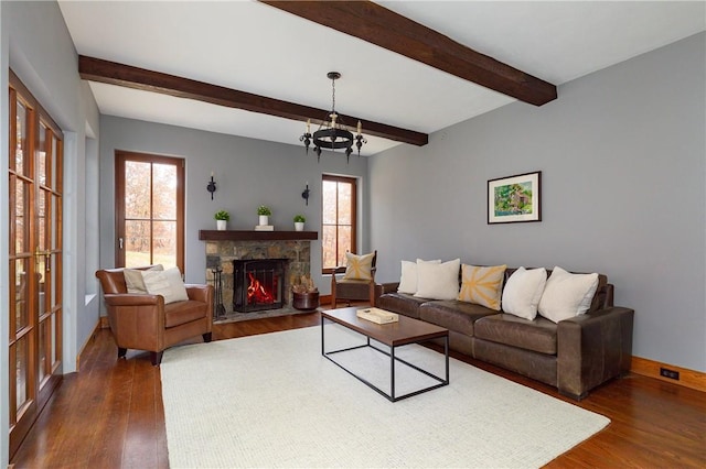 living room featuring dark hardwood / wood-style flooring, a chandelier, and a wealth of natural light