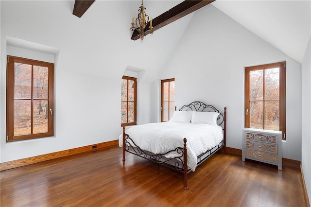 bedroom with dark wood-type flooring, a chandelier, high vaulted ceiling, and beamed ceiling