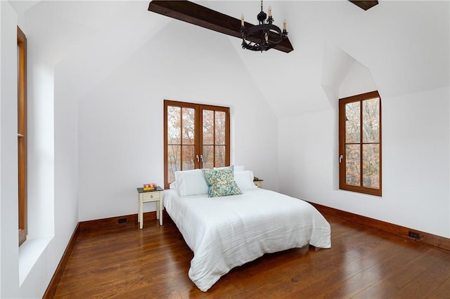 bedroom with dark hardwood / wood-style flooring, a chandelier, beam ceiling, and multiple windows