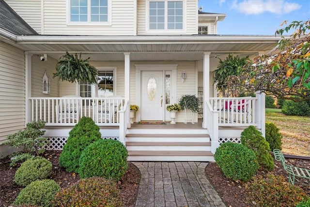 view of exterior entry with a porch