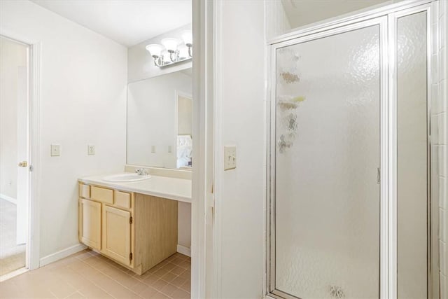 bathroom featuring tile patterned flooring, vanity, and walk in shower