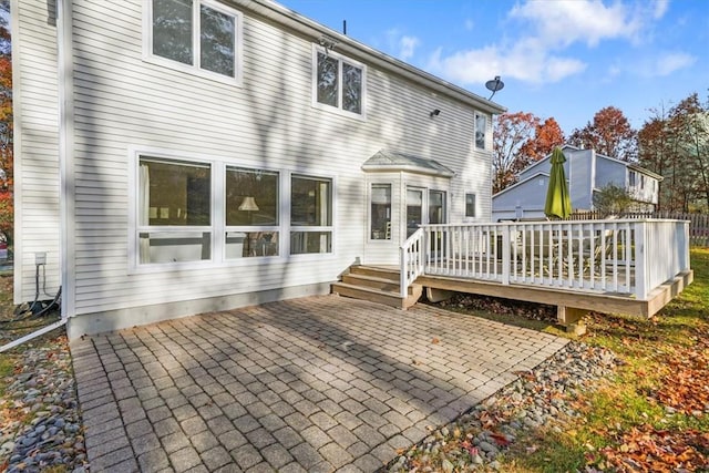 rear view of property with a patio area and a wooden deck