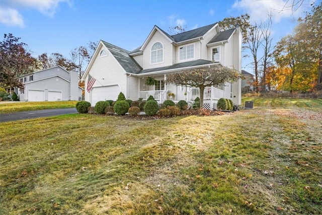 view of front of home featuring a porch, central air condition unit, and a front lawn