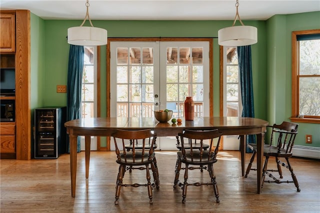 dining room with hardwood / wood-style floors, beverage cooler, and french doors