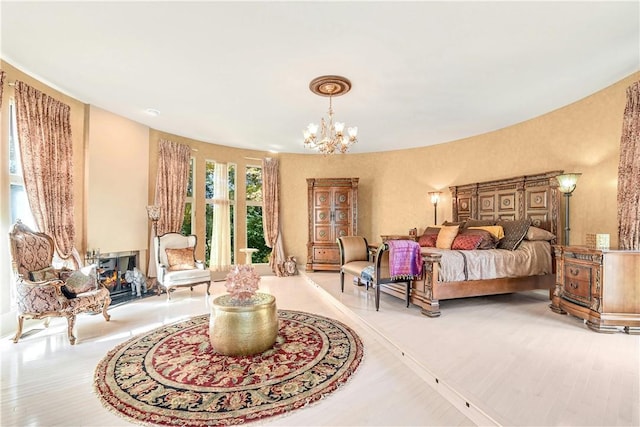 bedroom with light wood-type flooring and a chandelier