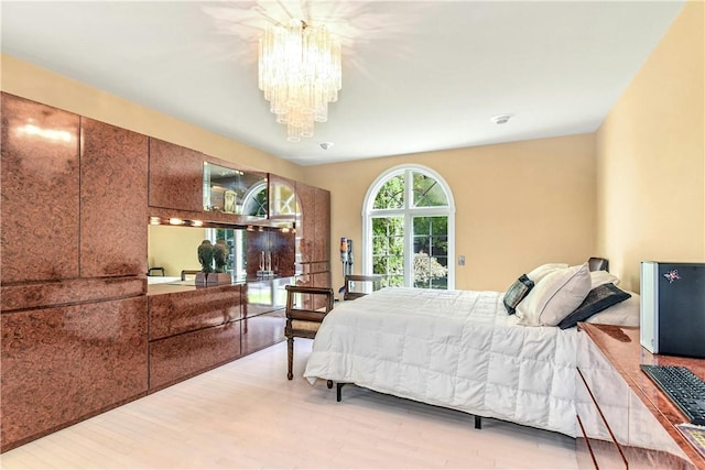 bedroom featuring light hardwood / wood-style floors and a notable chandelier