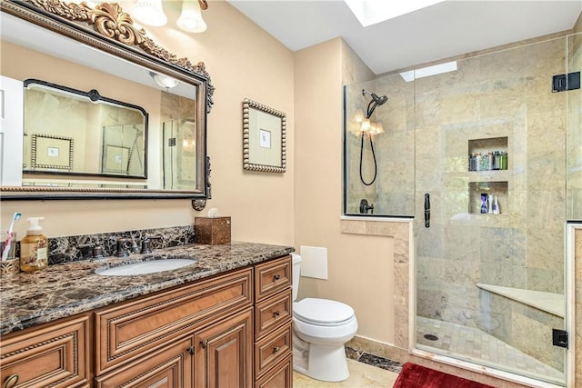 bathroom featuring a skylight, tile patterned floors, vanity, toilet, and a shower with shower door