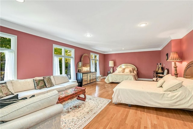 bedroom with crown molding and light hardwood / wood-style flooring