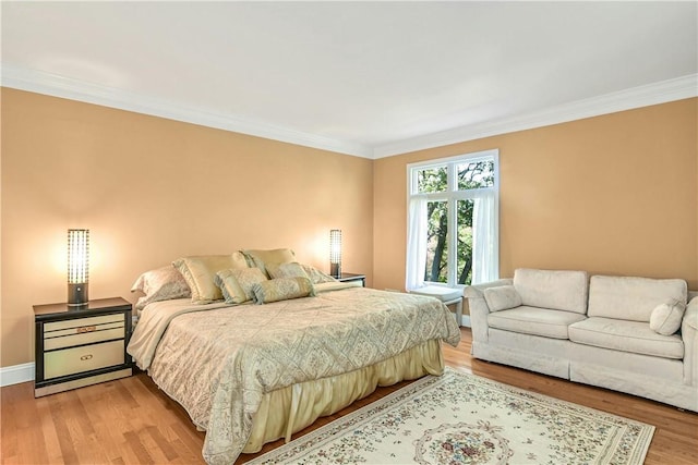 bedroom with light hardwood / wood-style flooring and ornamental molding