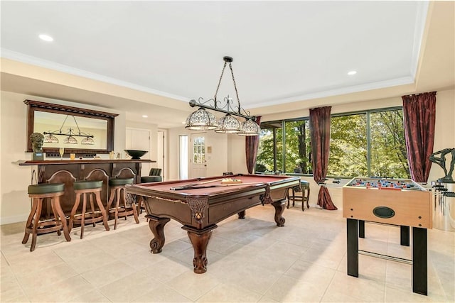 game room featuring bar area, light tile patterned floors, ornamental molding, and pool table