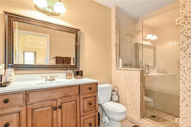 bathroom featuring tile patterned floors, vanity, toilet, and an enclosed shower