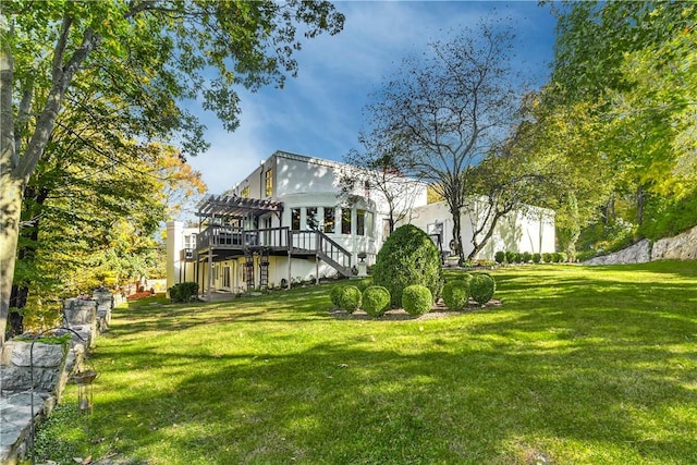 rear view of house with a pergola, a yard, and a wooden deck