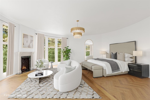 bedroom featuring light parquet flooring, a premium fireplace, and multiple windows