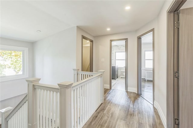 hall with radiator and light hardwood / wood-style flooring