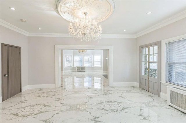 unfurnished dining area featuring crown molding, radiator, and a chandelier