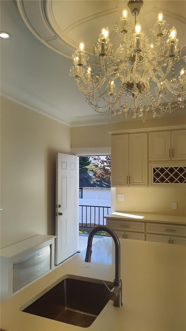 kitchen with an inviting chandelier, crown molding, and sink