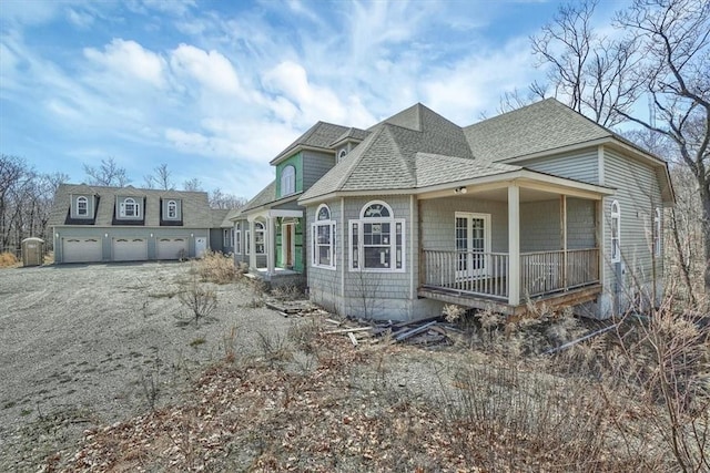 view of side of property featuring covered porch