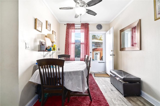 dining space featuring hardwood / wood-style flooring, ceiling fan, and crown molding