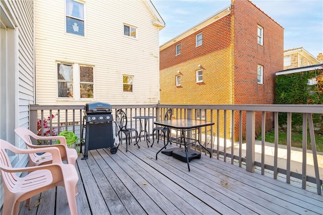 wooden deck with a grill