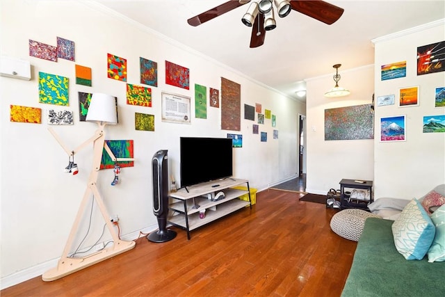 living room featuring hardwood / wood-style flooring, ceiling fan, and ornamental molding