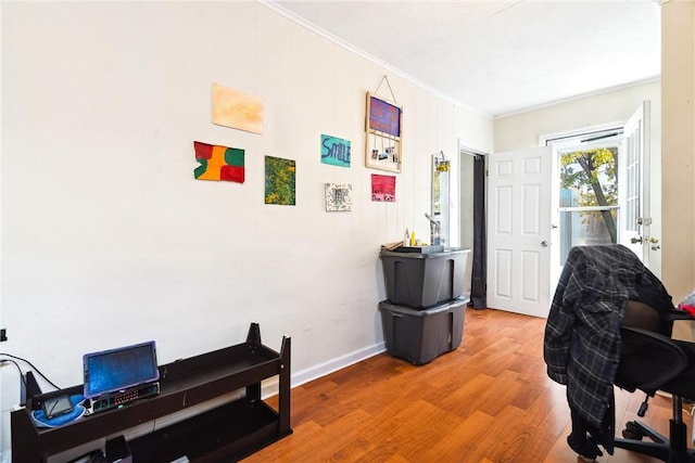 office with hardwood / wood-style floors and crown molding