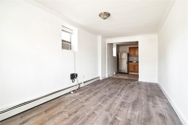 unfurnished room with light wood-type flooring, crown molding, cooling unit, and a baseboard heating unit