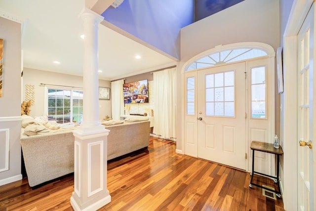 entrance foyer featuring decorative columns and hardwood / wood-style flooring