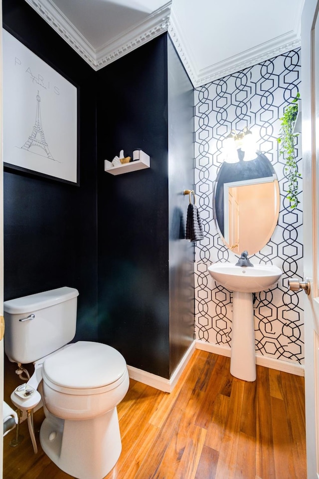 bathroom with hardwood / wood-style floors, sink, toilet, and crown molding