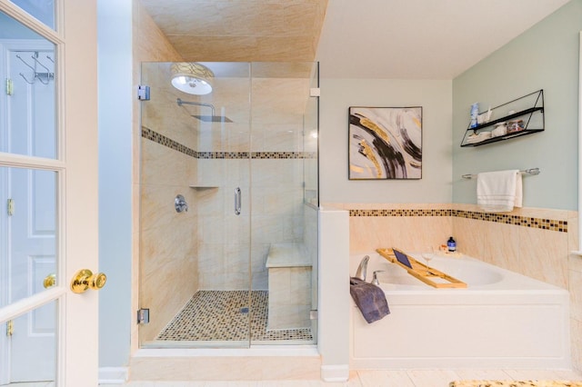 bathroom featuring plus walk in shower and tile patterned floors