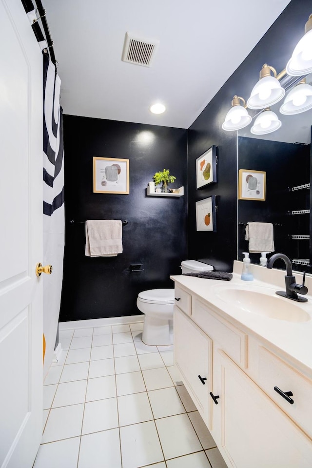 bathroom featuring tile patterned floors, vanity, and toilet