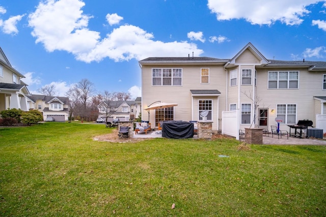 rear view of house with a yard and a patio area