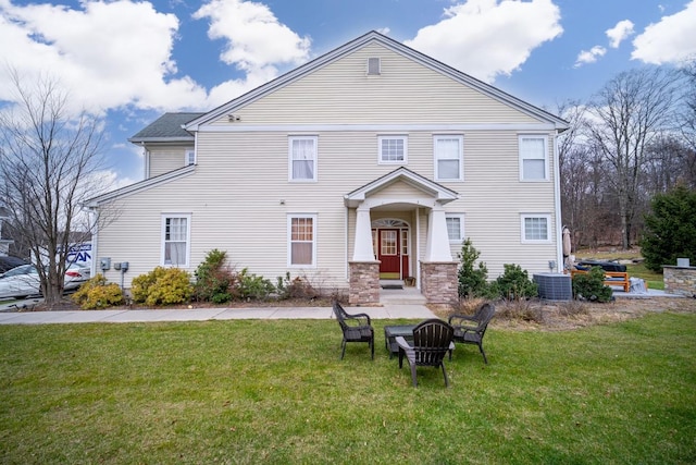 view of front of house featuring central AC unit and a front yard