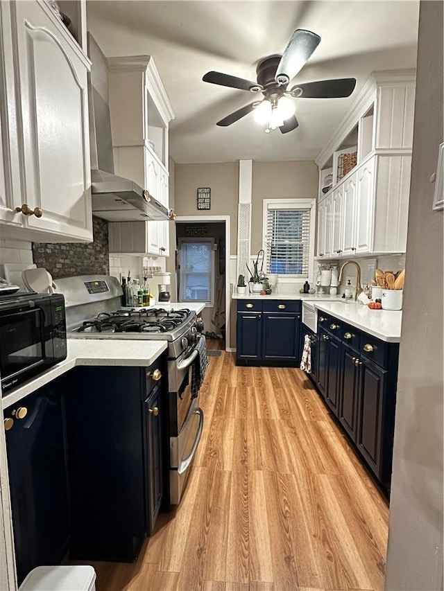 kitchen with wood walls and blue cabinets