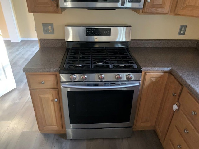 kitchen featuring appliances with stainless steel finishes and light wood-type flooring