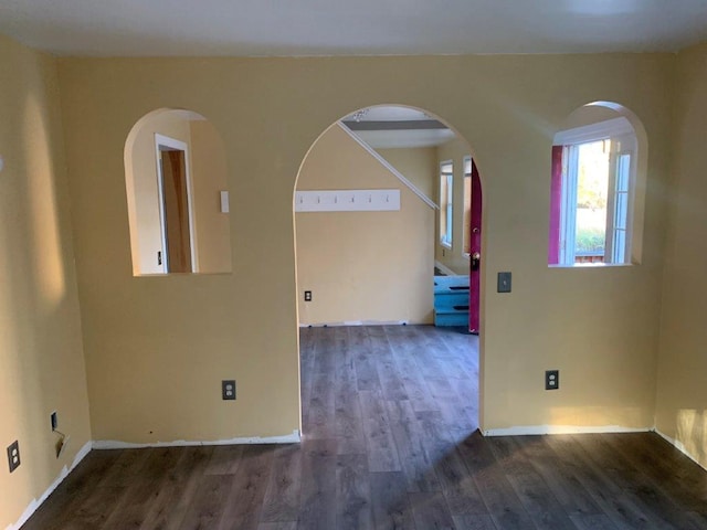 empty room with dark hardwood / wood-style flooring