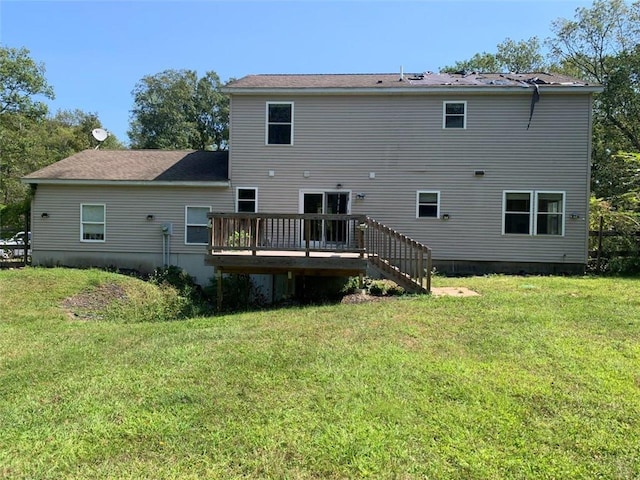 rear view of property featuring a yard and a wooden deck