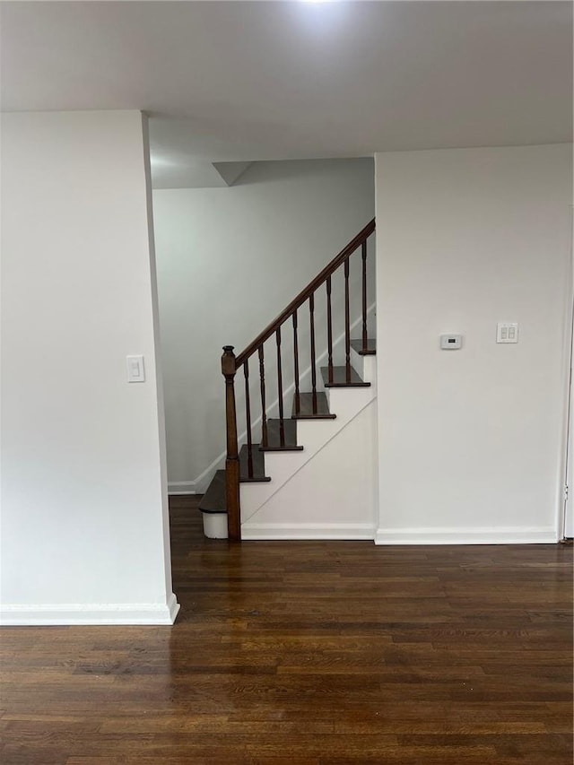 stairway with hardwood / wood-style floors