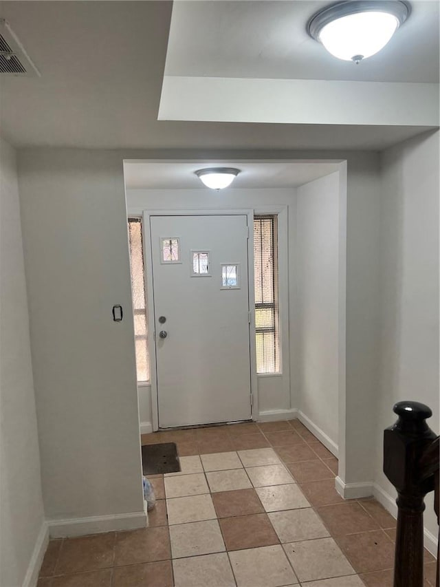 foyer entrance with tile walls