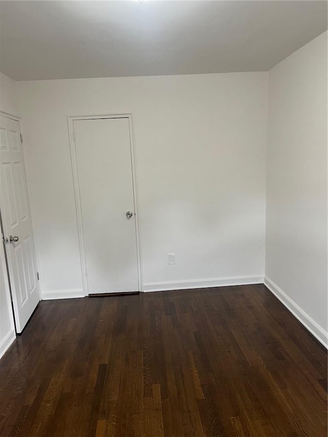 unfurnished room featuring wooden walls