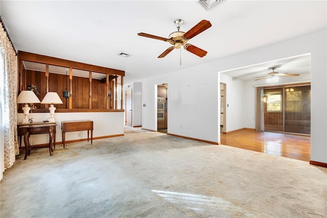 unfurnished living room featuring light hardwood / wood-style flooring and ceiling fan