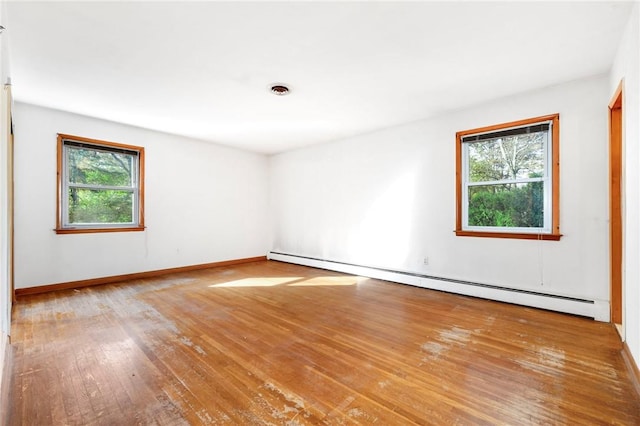 spare room featuring light hardwood / wood-style floors and a baseboard radiator