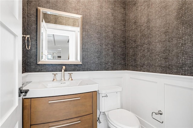 bathroom featuring toilet and vanity