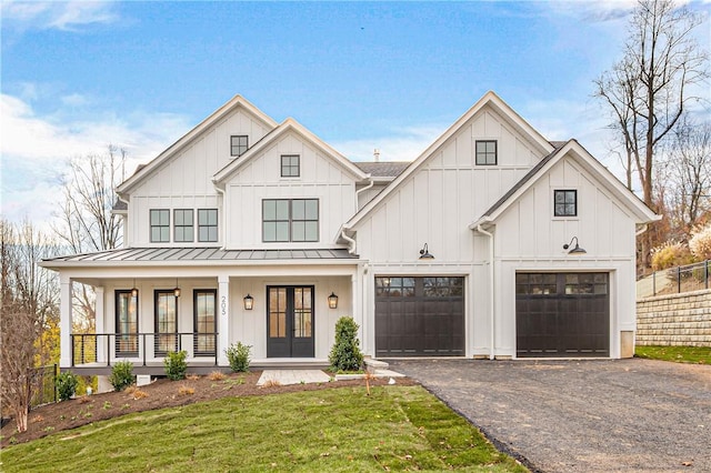 modern farmhouse featuring a front lawn and covered porch