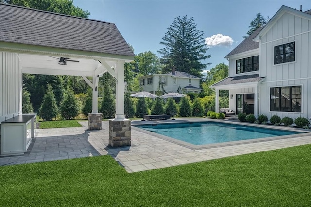 view of pool featuring ceiling fan, a gazebo, a yard, and a patio