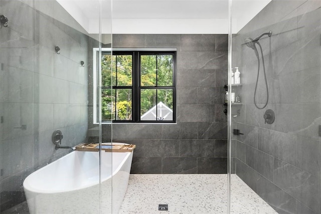 bathroom featuring vaulted ceiling, independent shower and bath, and a healthy amount of sunlight