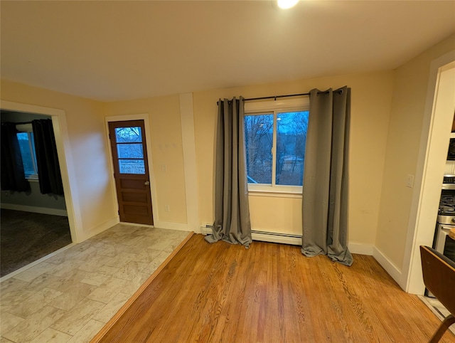 foyer featuring a baseboard radiator and light wood-type flooring