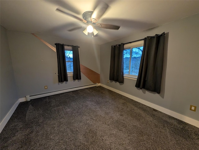 spare room featuring carpet flooring, ceiling fan, a healthy amount of sunlight, and a baseboard heating unit